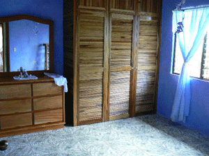 The second colorful bedroom sports a large wardrobe. 